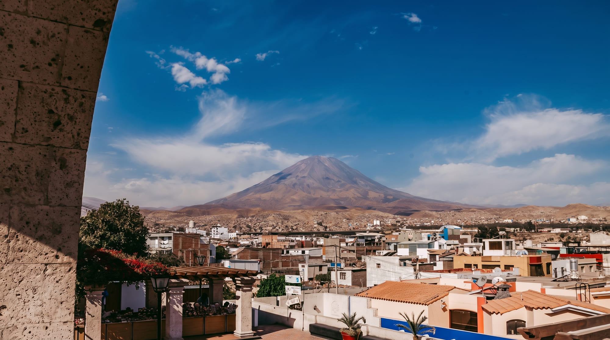 El Misti volcano seen through a sillar stone arch in Yanahuara, over the rooftops of Arequipa